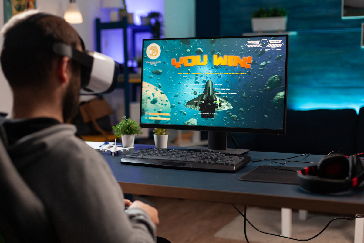 Player using vr glasses to win video games on computer